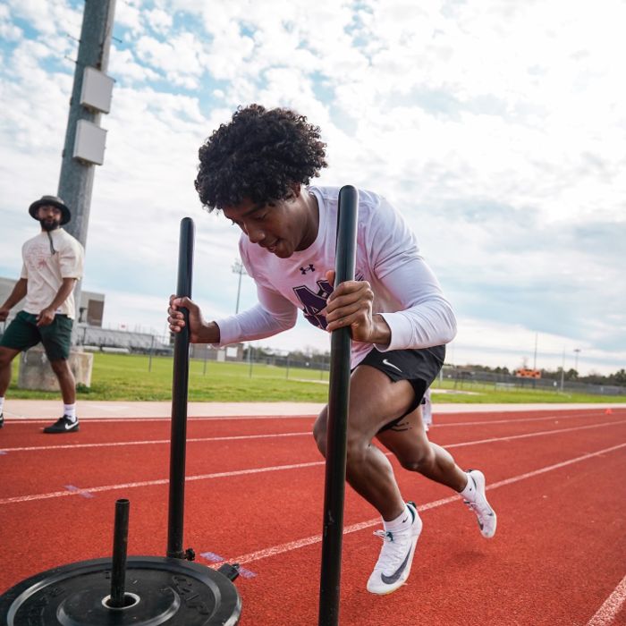 TJ Hart watching an athlete train on the track