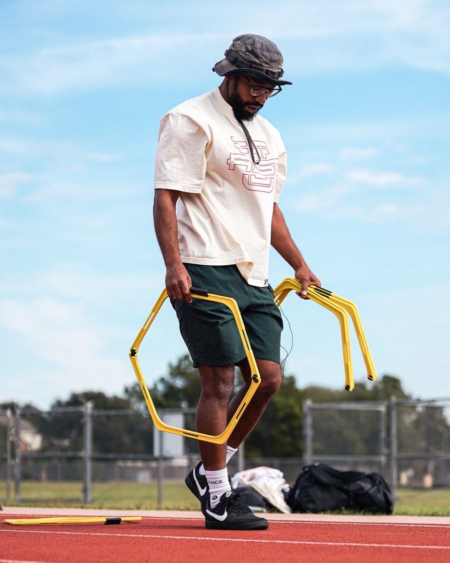 Coach TJ Hart on the track during a training session